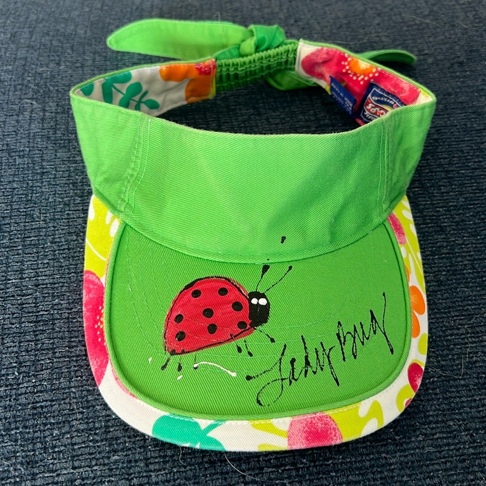 Kids size 4-6x fun colorful lady bug green visor with fun colorful trim artwork